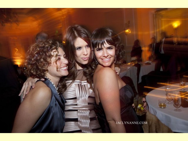 Three ladies enjoying music, smiling